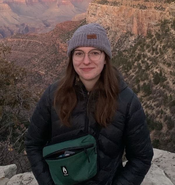 Aimee in front of a mountainous landscape