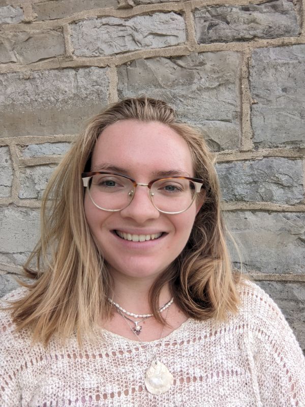 Erika in front of a brick wall