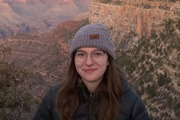 Aimee in front of a mountainous landscape