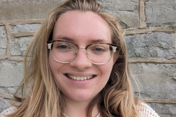 Erika in front of a brick wall