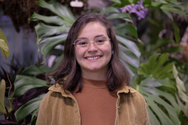 MJ standing in front of some foliage